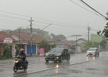 Pengendara sepeda motor menerobos hujan lebat yang mengguyur ruas Jalan Raya Cilacap-Yogyakarta, Desa Kalisabuk, Kecamatan Kesugihan, Kabupaten Cilacap, Jumat (1/12/2023) pagi.